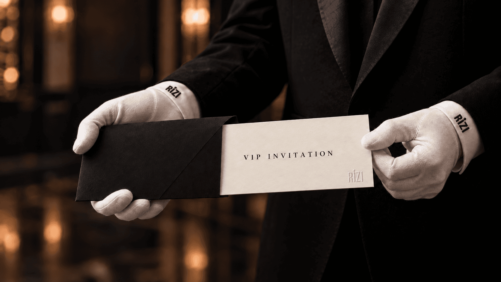 Two embroidered white gloves holding a VIP invitation with a small Rizi stamp.